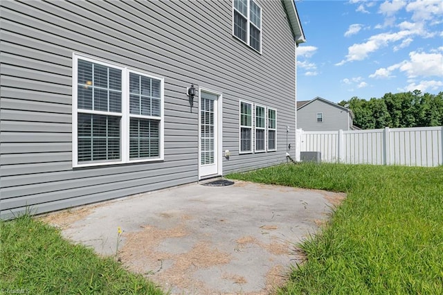 back of property featuring a patio area, fence, and a yard