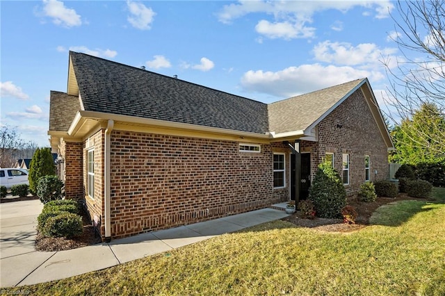 view of side of home featuring a lawn