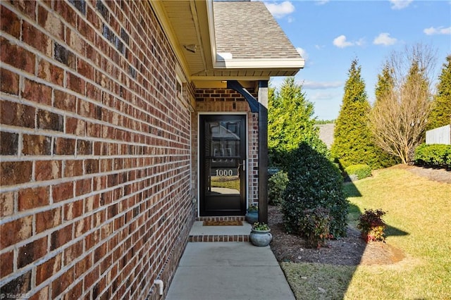 entrance to property featuring a yard