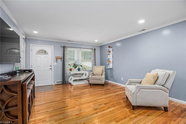 living area featuring light hardwood / wood-style flooring, a baseboard radiator, and ornamental molding