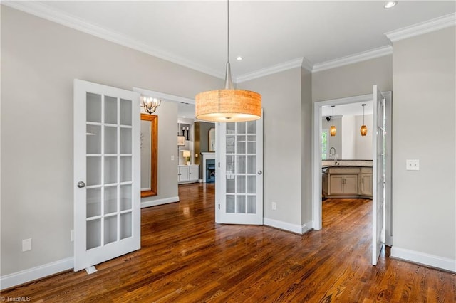 unfurnished dining area featuring crown molding, dark wood-style flooring, baseboards, recessed lighting, and french doors