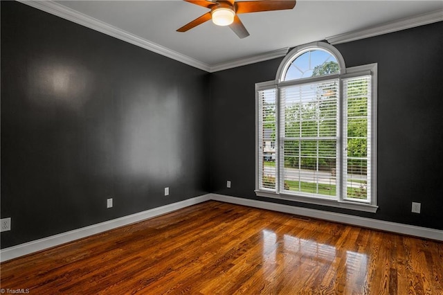 unfurnished room featuring baseboards, crown molding, ceiling fan, and wood finished floors