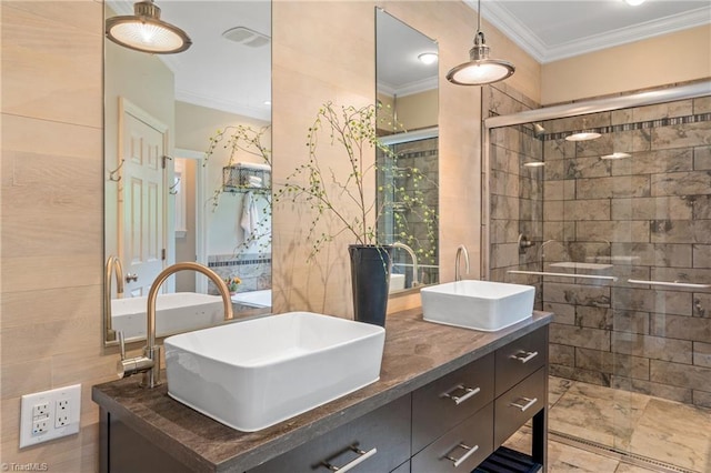 bathroom featuring a sink, a stall shower, and double vanity