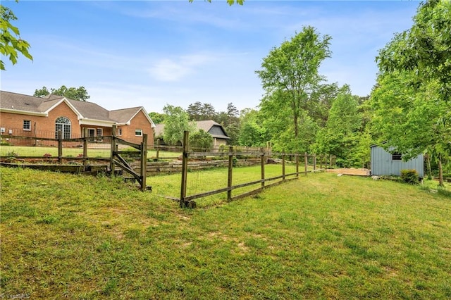 view of yard featuring fence and an outbuilding