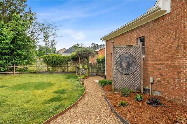 view of yard with fence and a gate