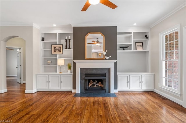 unfurnished living room with a ceiling fan, baseboards, and wood finished floors
