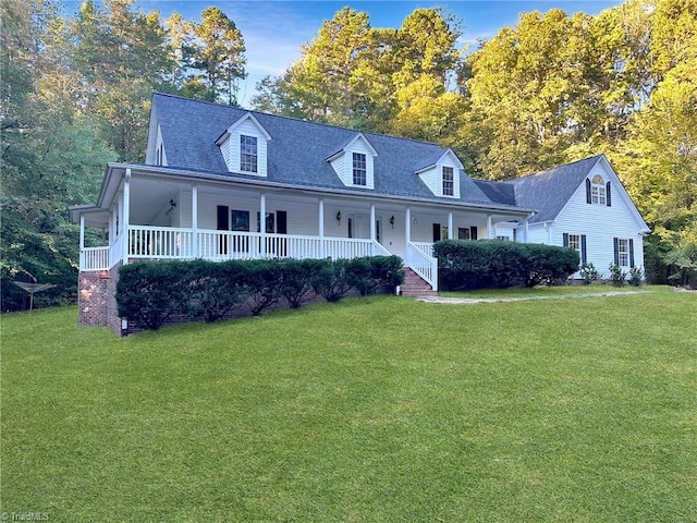 cape cod-style house with a front lawn and a porch