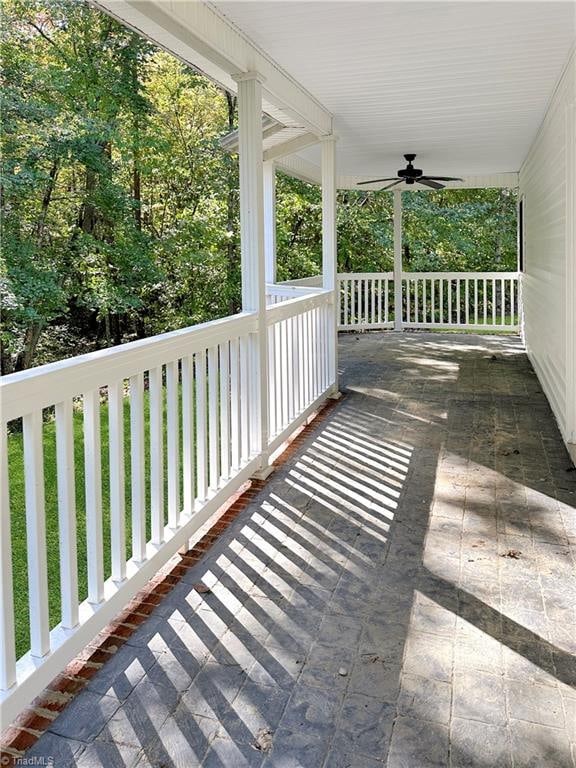 deck featuring ceiling fan and a porch