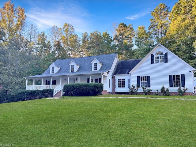 cape cod-style house featuring a porch and a front lawn