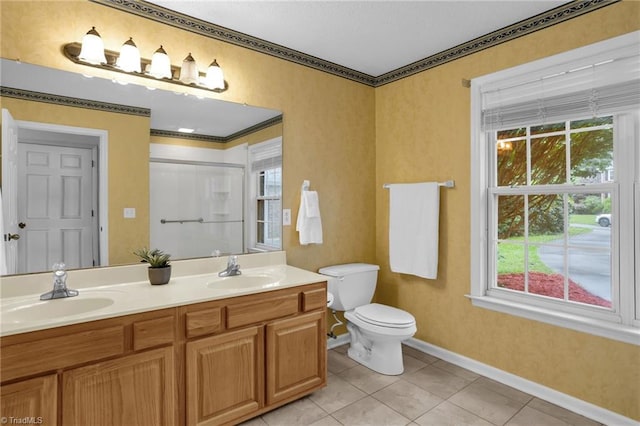 7060 Orchard Path Dr, Clemmons, NC 27012 - bathroom with double vanity, toilet, baseboards, a shower with door, and tile patterned floors