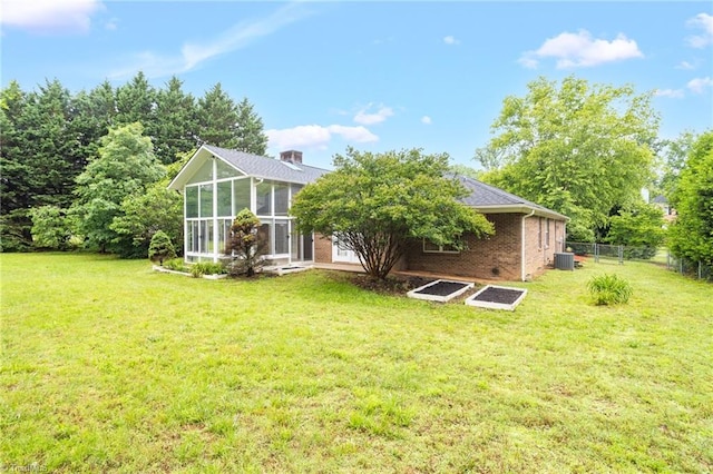 7060 Orchard Path Dr, Clemmons, NC 27012 - back of property with brick siding, a sunroom, and central AC