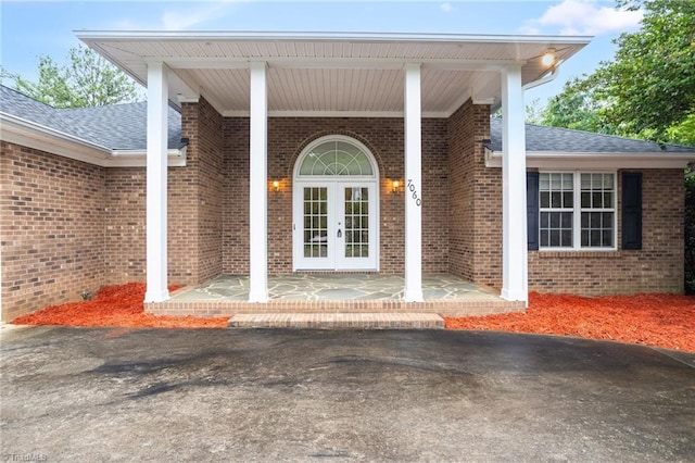 7060 Orchard Path Dr, Clemmons, NC 27012 - view of exterior entry featuring roof with shingles, french doors, and brick siding