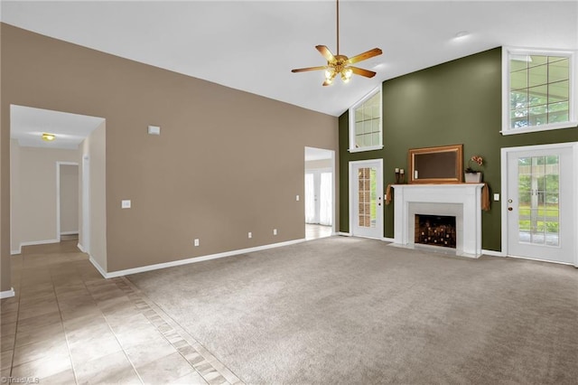 7060 Orchard Path Dr, Clemmons, NC 27012 - unfurnished living room with high vaulted ceiling, a ceiling fan, a fireplace with flush hearth, and baseboards