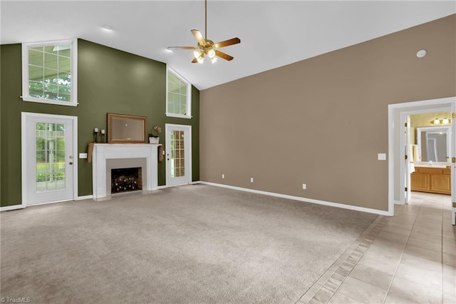 7060 Orchard Path Dr, Clemmons, NC 27012 - unfurnished living room with high vaulted ceiling, a ceiling fan, baseboards, a fireplace with flush hearth, and light tile patterned flooring