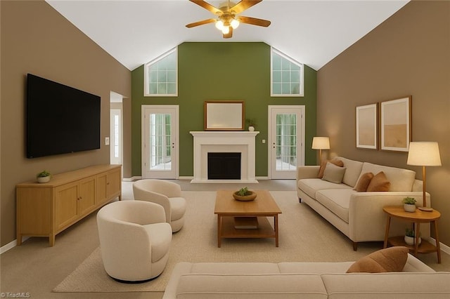 7060 Orchard Path Dr, Clemmons, NC 27012 - living room featuring a ceiling fan, light carpet, a fireplace with raised hearth, baseboards, and plenty of natural light