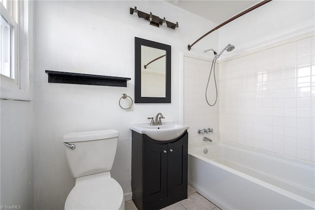 full bathroom featuring toilet, tiled shower / bath combo, vanity, and tile patterned floors