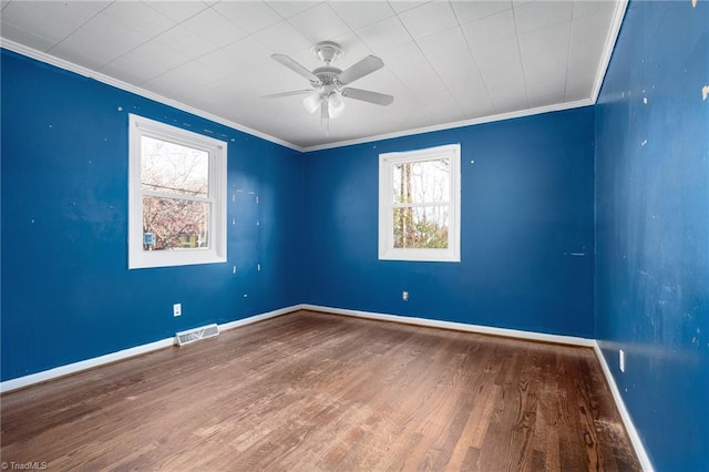 empty room featuring ceiling fan, hardwood / wood-style floors, and ornamental molding