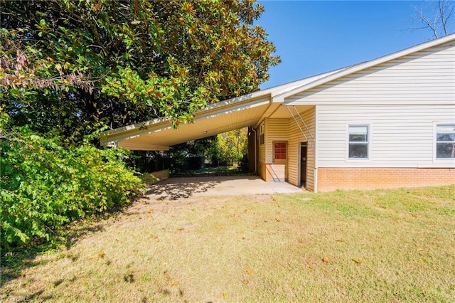 view of car parking with a yard and a carport