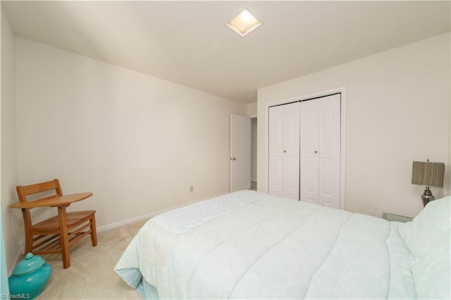 bedroom with light carpet and a closet