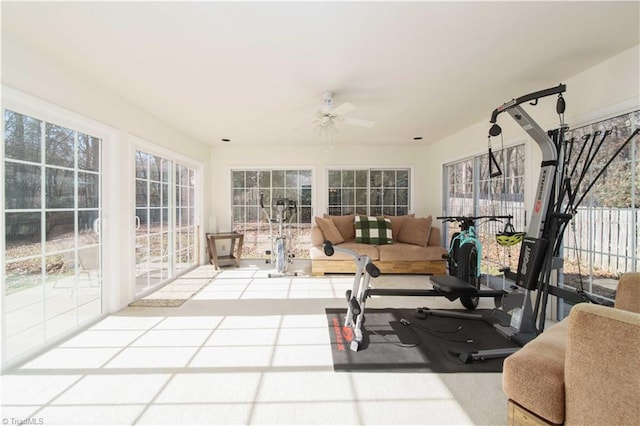 workout area with ceiling fan and tile patterned floors