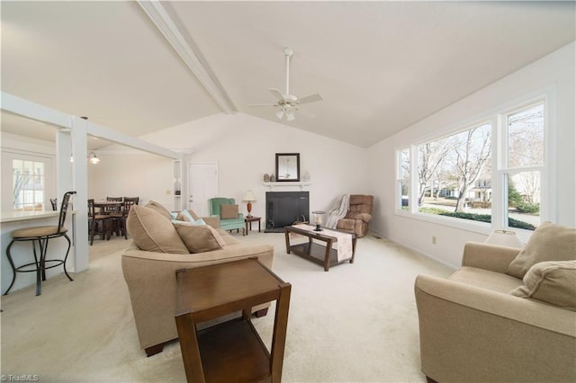 carpeted living room featuring vaulted ceiling with beams and ceiling fan