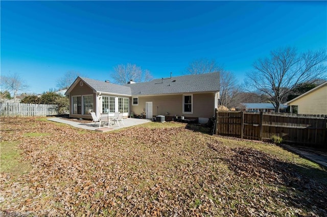 back of property with a patio area, central air condition unit, and a lawn