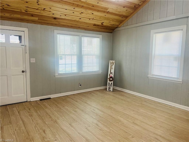 entrance foyer featuring wooden ceiling, light wood-style flooring, visible vents, baseboards, and vaulted ceiling