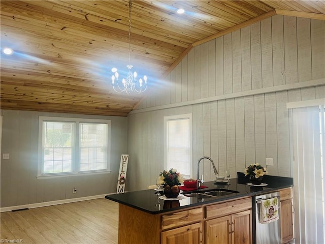 kitchen with lofted ceiling, dishwasher, dark countertops, and a sink