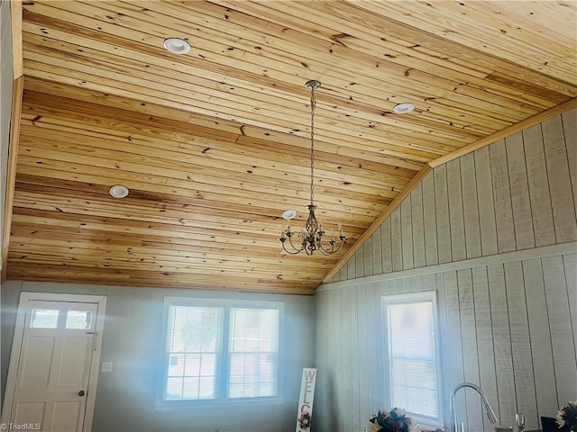 interior space with lofted ceiling, wood ceiling, and a notable chandelier