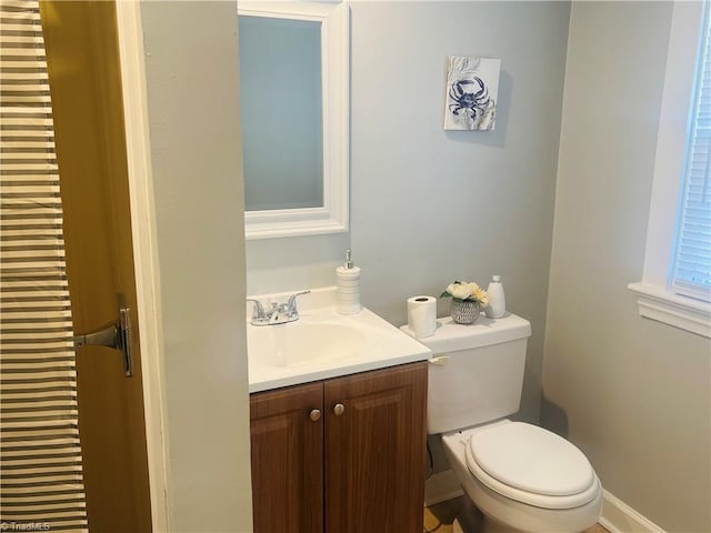 half bathroom featuring toilet and vanity