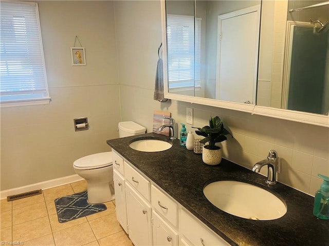 full bath with a shower with door, visible vents, a sink, and tile patterned floors