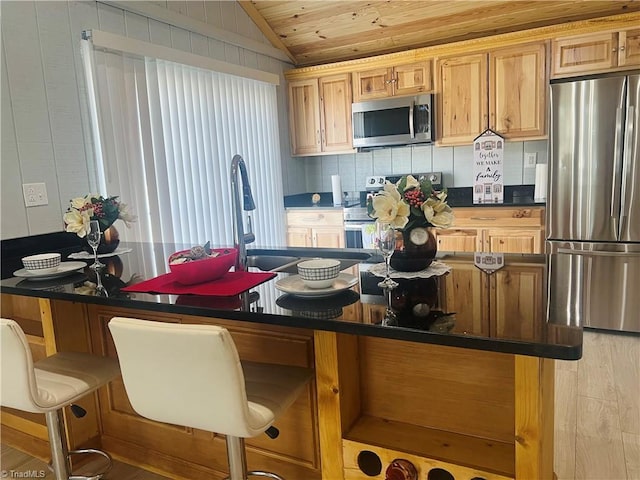 kitchen with decorative backsplash, dark countertops, wood ceiling, vaulted ceiling, and stainless steel appliances