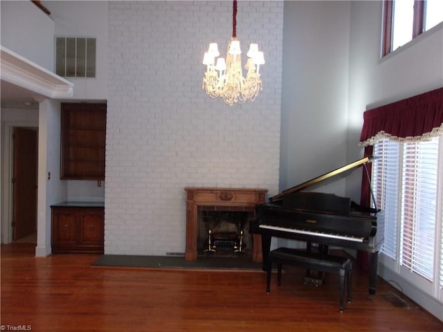 misc room featuring dark hardwood / wood-style flooring and a chandelier