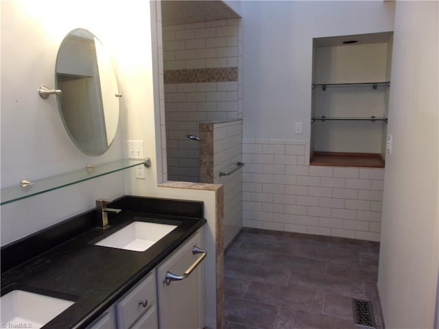 bathroom featuring vanity and tile walls