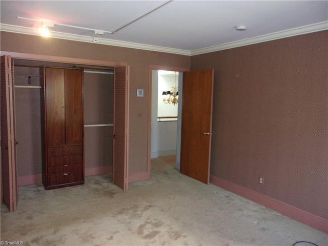 unfurnished bedroom featuring light colored carpet, a closet, and crown molding