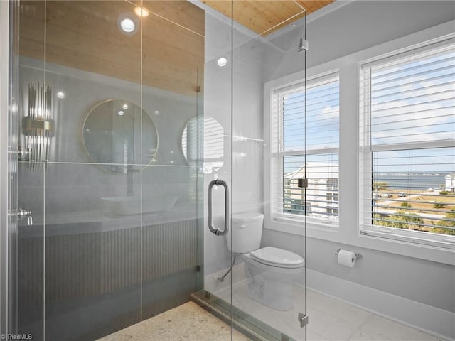 bathroom with an enclosed shower and toilet