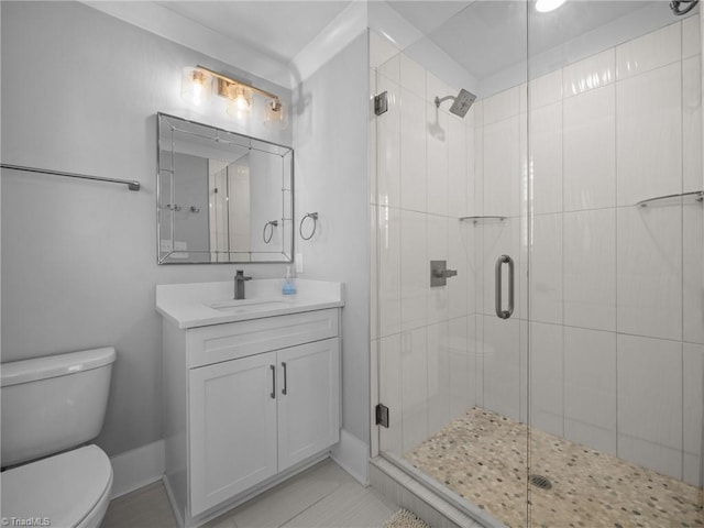 bathroom featuring an enclosed shower, vanity, toilet, and tile patterned flooring