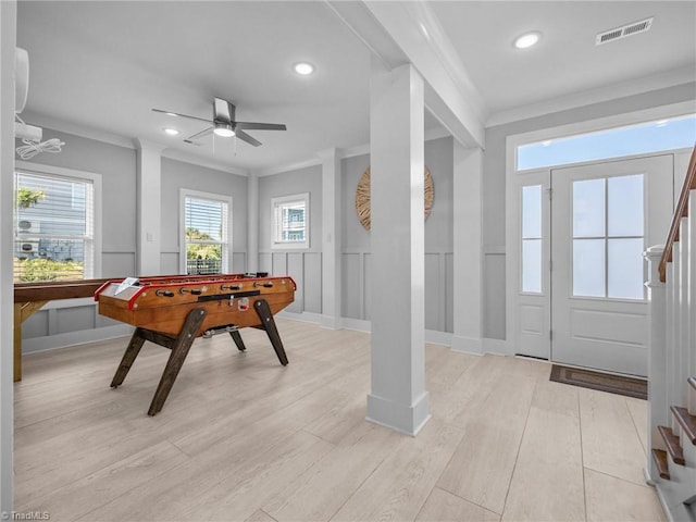 playroom featuring crown molding, ceiling fan, and light wood-type flooring