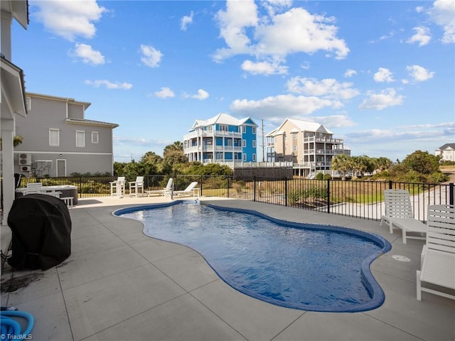 view of pool featuring a patio area and a grill