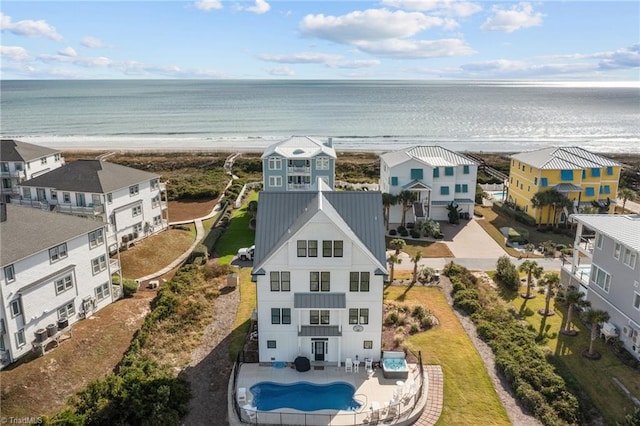 drone / aerial view with a water view and a beach view