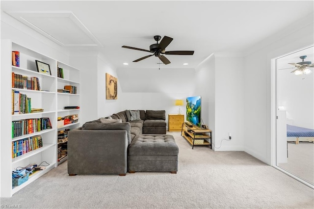 carpeted living room featuring built in shelves and ceiling fan