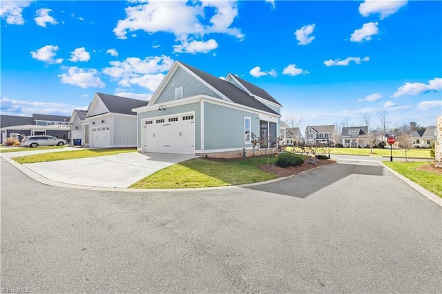 view of side of home featuring a garage and a yard