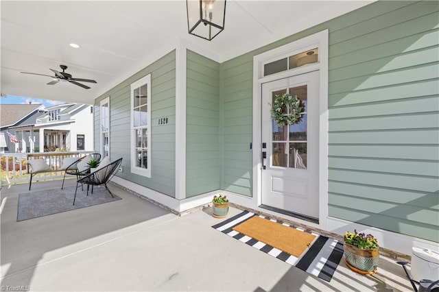 doorway to property with ceiling fan and covered porch