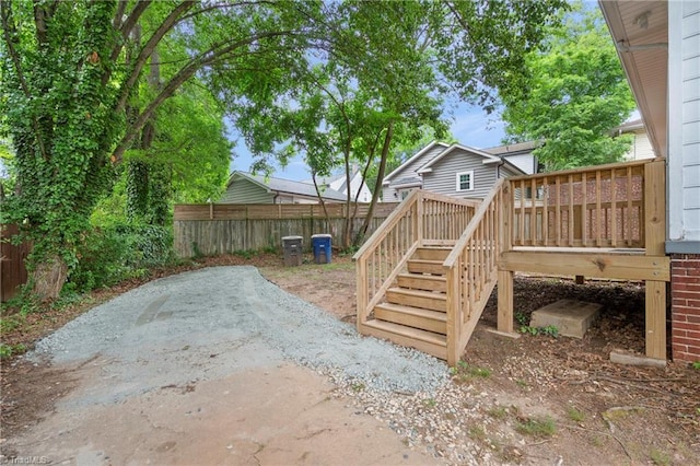 view of yard with fence, stairway, a deck, and a patio area