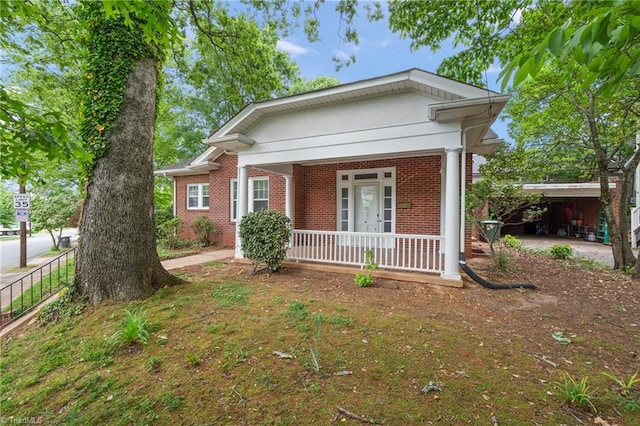 view of front facade featuring a porch and brick siding