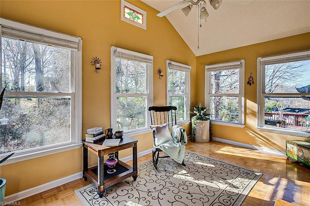 sunroom with ceiling fan and lofted ceiling