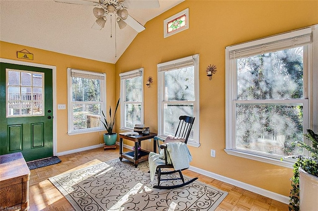 sunroom featuring ceiling fan and vaulted ceiling