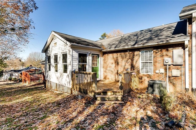 rear view of property featuring a deck