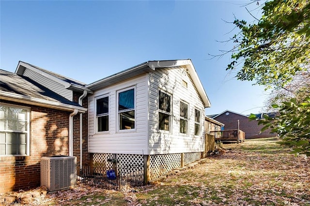 view of home's exterior featuring a deck and central AC unit