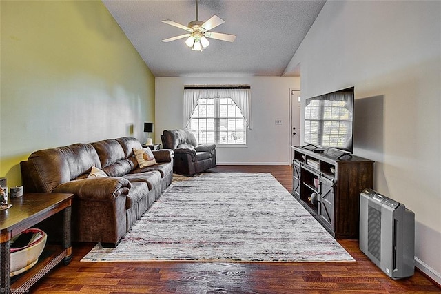 living room with a textured ceiling, dark hardwood / wood-style floors, plenty of natural light, and ceiling fan